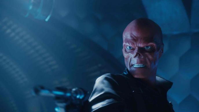 red skull character from captain america the first avenger looking menacingly while holding a gun