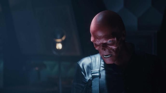 red skull from captain america the first avenger in a dimly lit room looking down menacingly