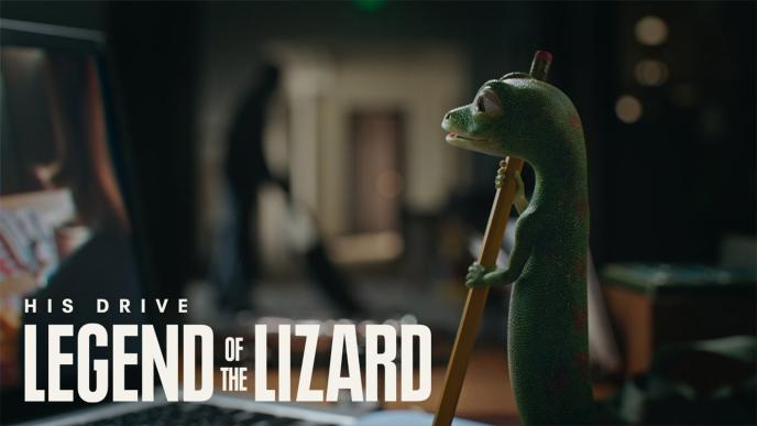 The GEICO gecko holds a pencil. The words "His Rise. Legend of the Lizard" is on the photo 