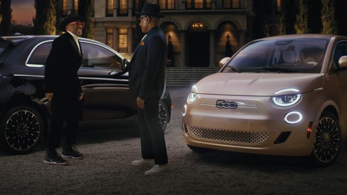 Spike Lee and Giancarlo Esposito next two two Fiat cars, outside of a mansion