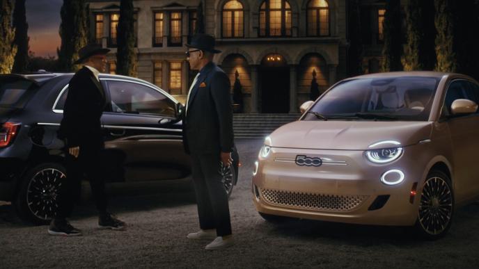 Spike Lee and Giancarlo Esposito next two two Fiat cars, outside of a mansion