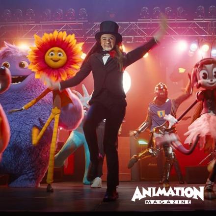 A girl on stage with many animated characters of different shapes and sizes - there is the Animation Magazine logo in the bottom right corner.