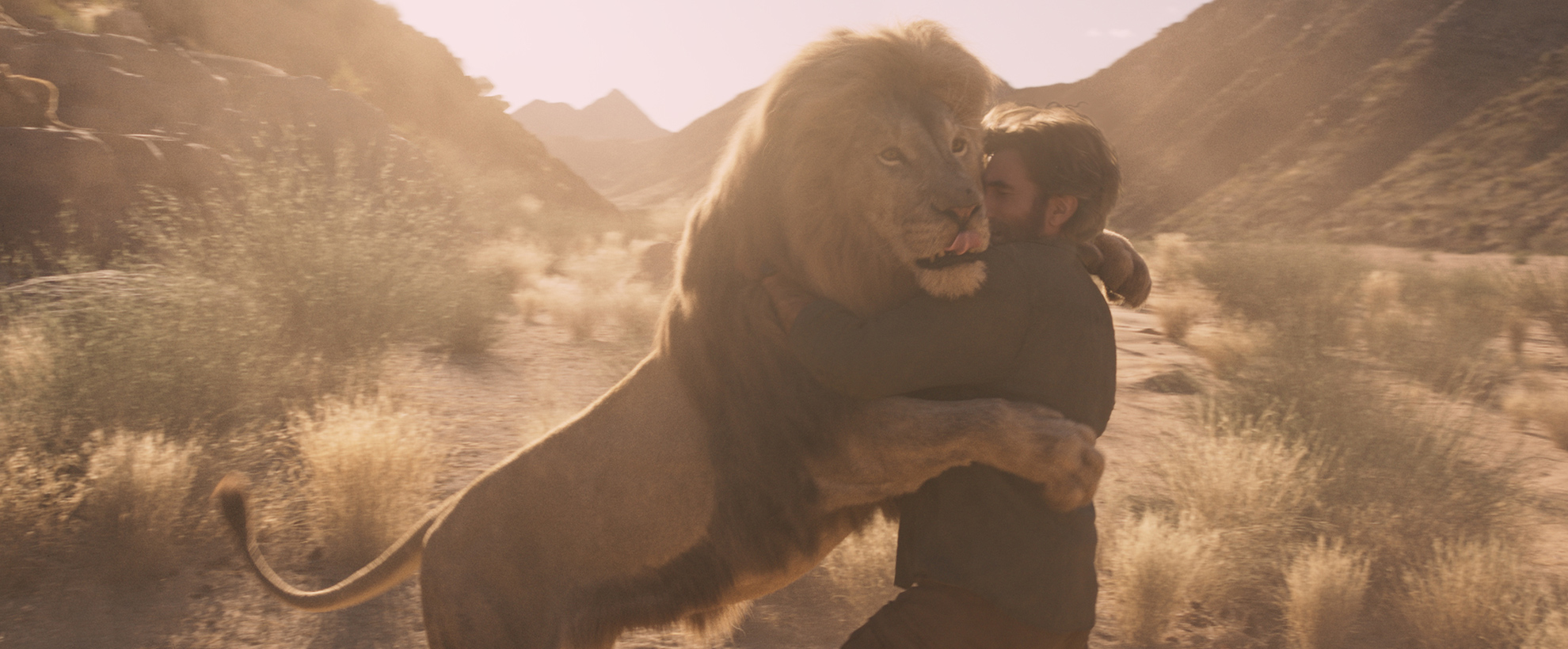 A lion embraces a man