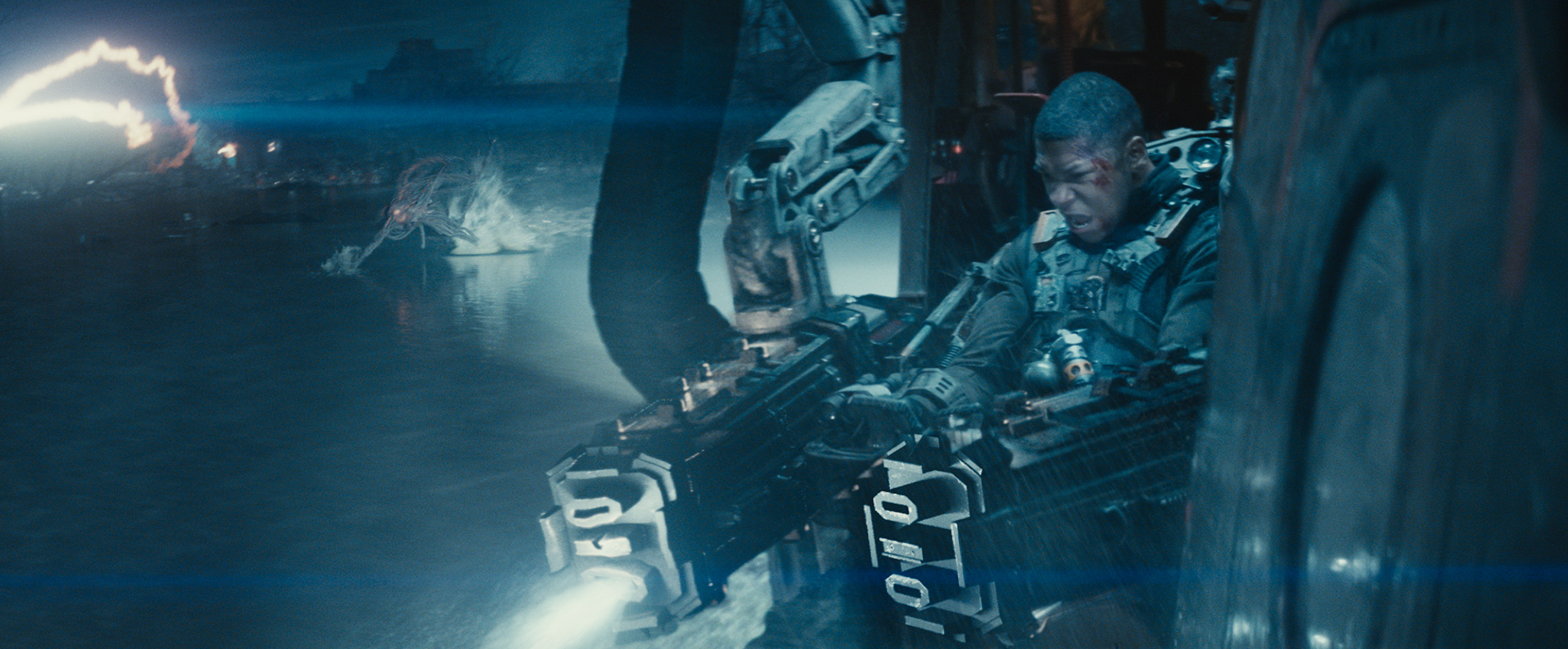 A young man fires two large machine guns
