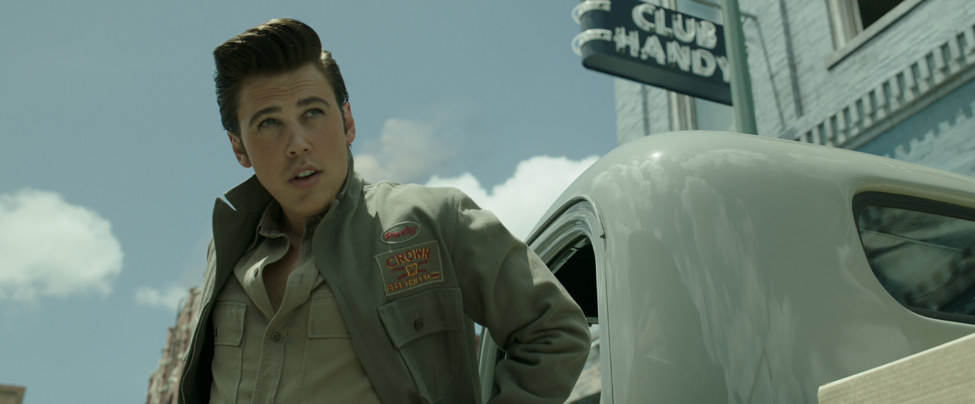 Austin Butler as Elvis, exiting a car wearing a khaki jacket
