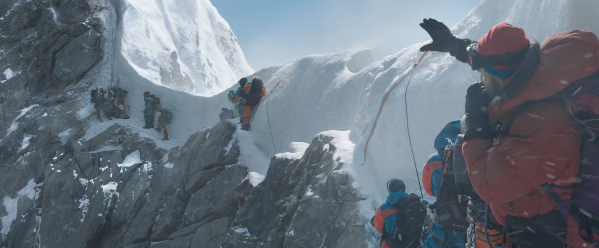 A group of hikers on the side of a snowy Mount Everest