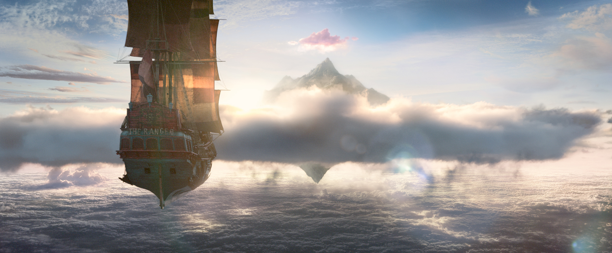 The jolly roger flies above the clouds against a blue sky, the sails lit up by the sun