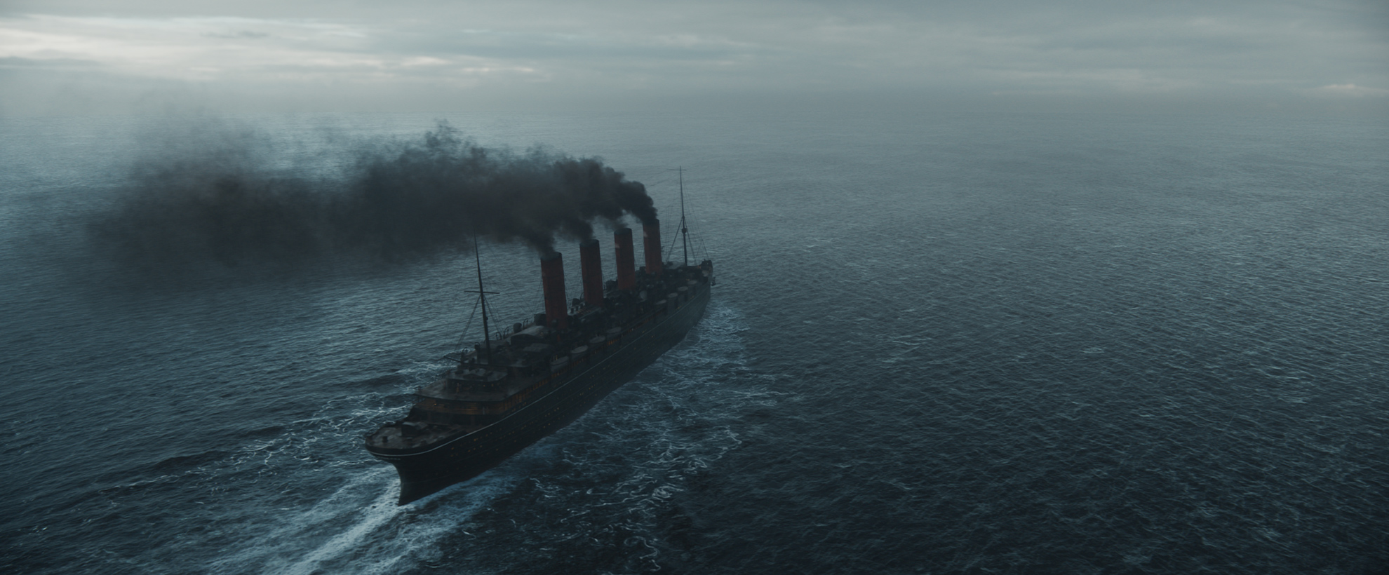 A boat on a wide ocean expanse, with four large smoking chimneys