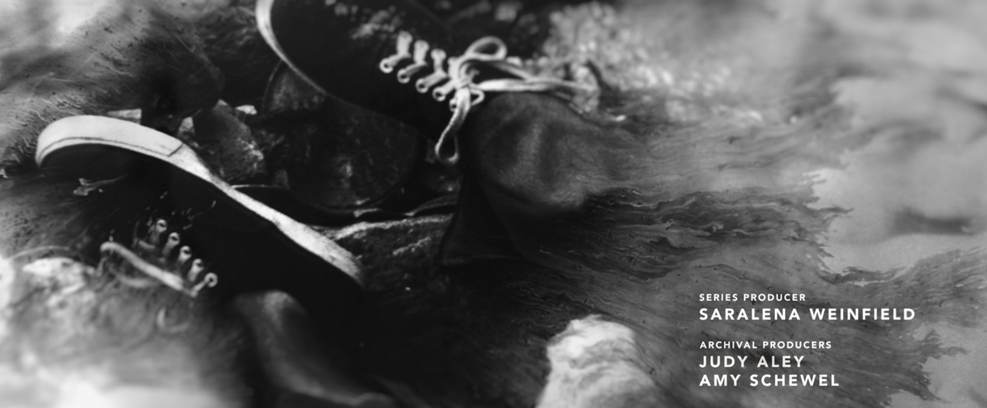 A frame from the titles of Atlanta's Missing and Murdered, black and white shot of laced shoes