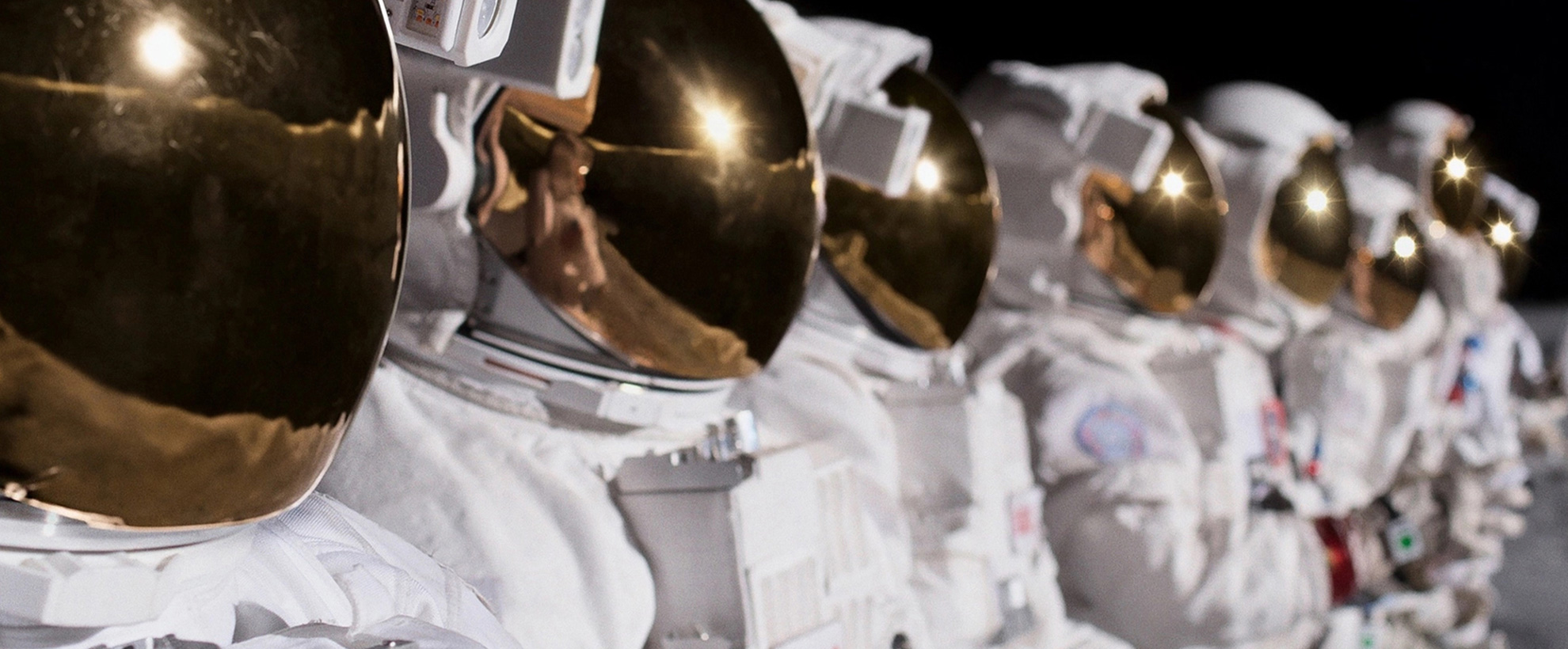 A row of astronauts, standing in a line in space