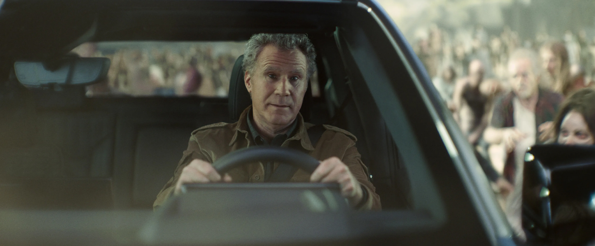 Will Ferrell drives an electric vehicle surrounded by zombies from Army of the Dead