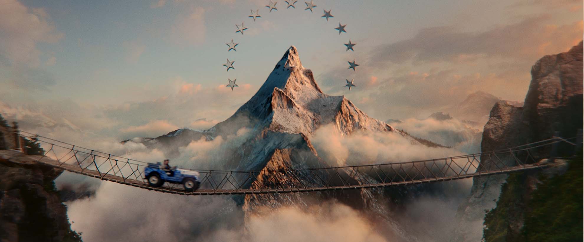 Paramount's mountain with ring of stars, beneath is a wooden suspension bridge with a vintage SUV driving over