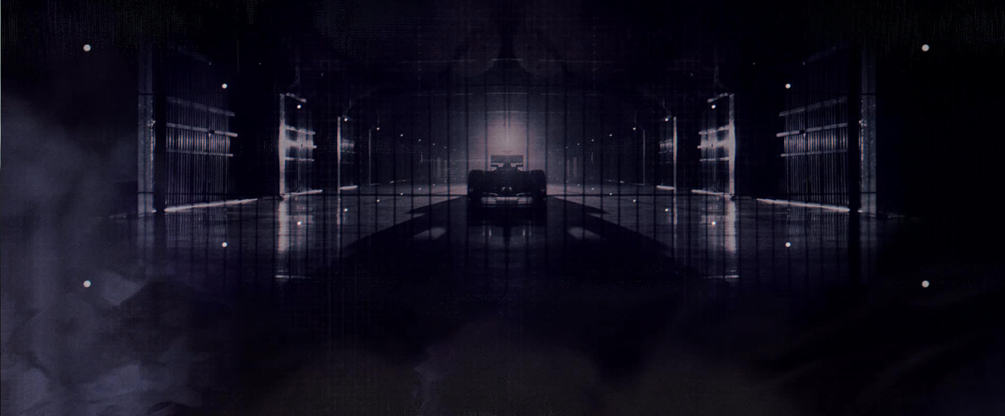 The silhouette of a formula 1 race car in a dark garage