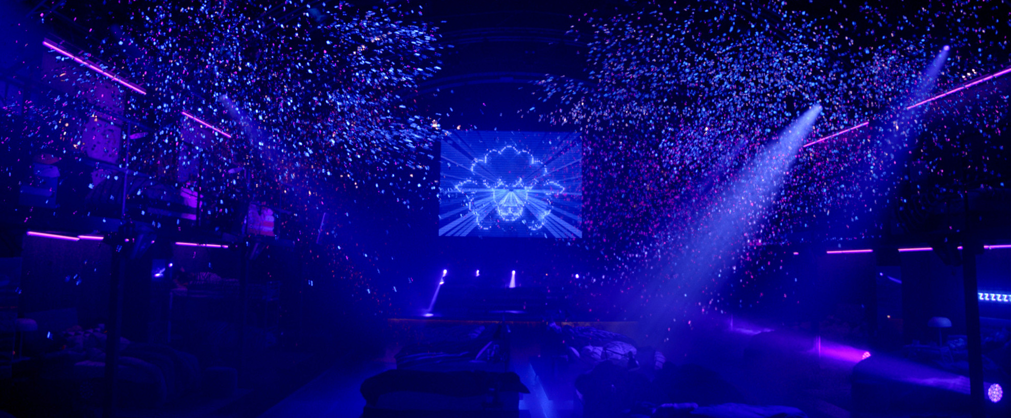 Blue and purple night club with confetti falling from the ceiling