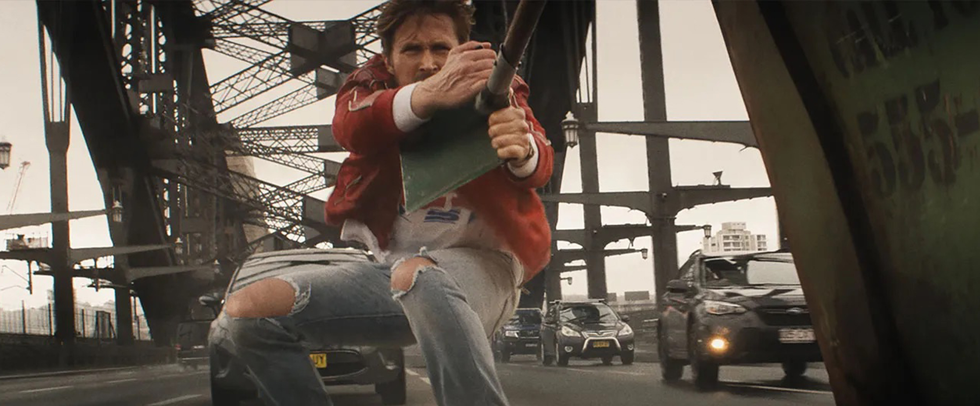 Ryan Gosling performs a stunt on the roof of a moving car