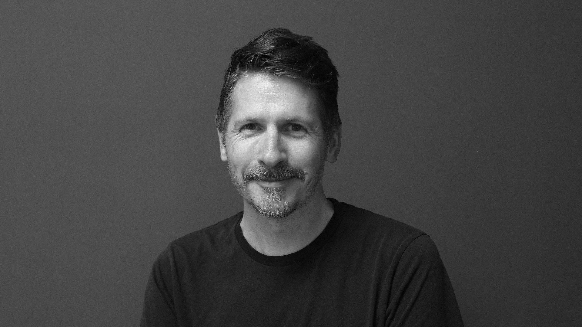 A black and white headshot of James Rogers