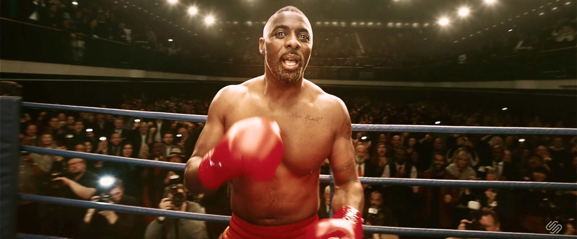 Idris Elba wearing boxing gloves