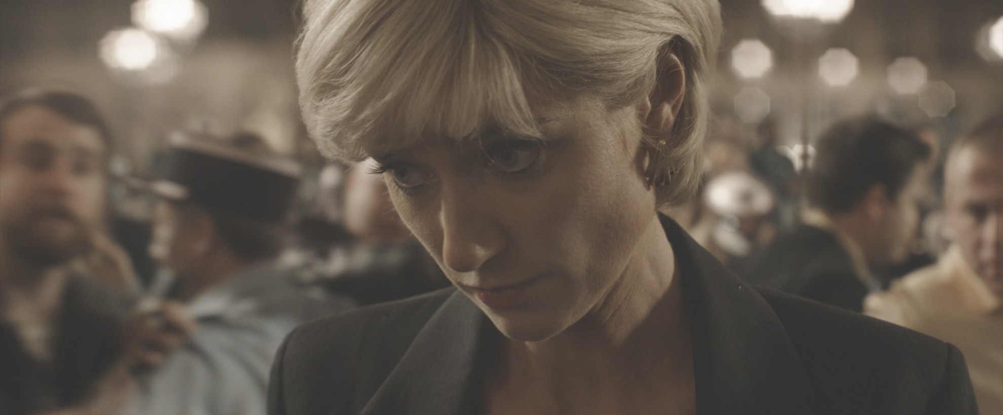 Elizabeth Debicki, playing Princess Diana looking down as paparazzi take photos