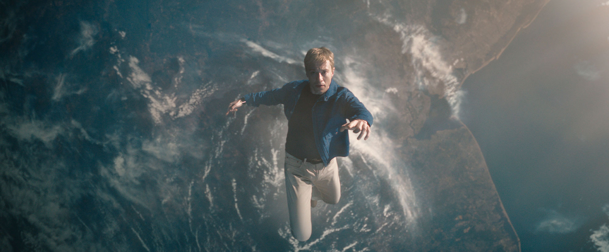 Looking down at Earth from space, a man falls down towards earth.