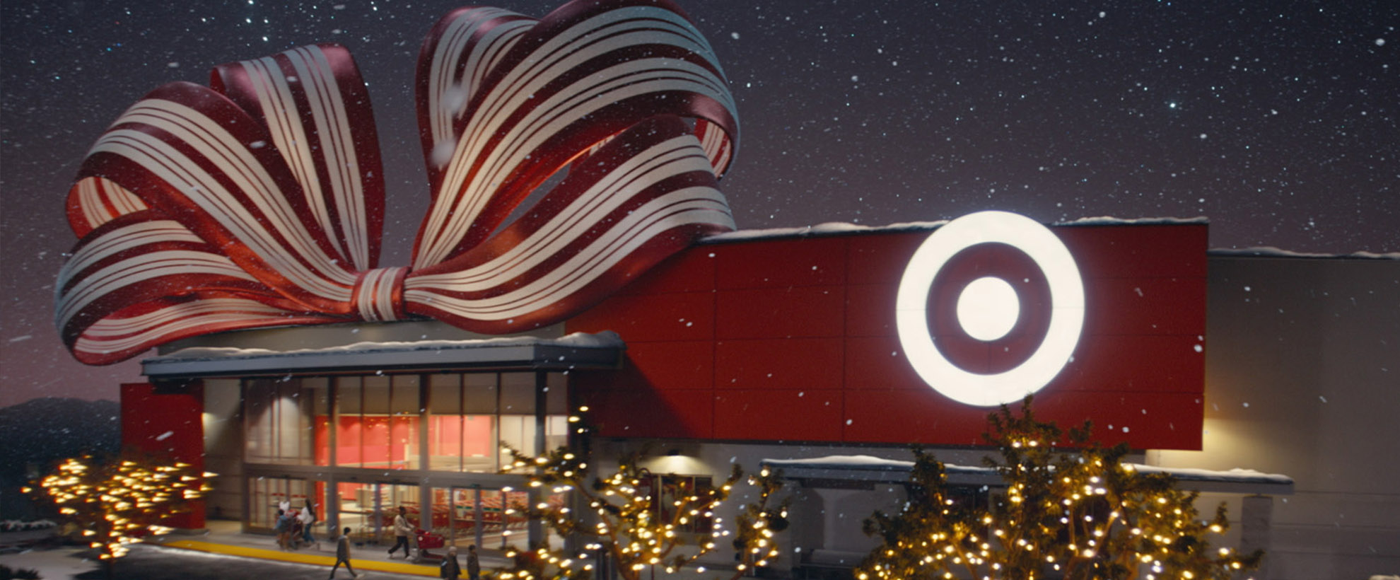 A Target store wrapped in a big bow and its trees covered in Christmas lights