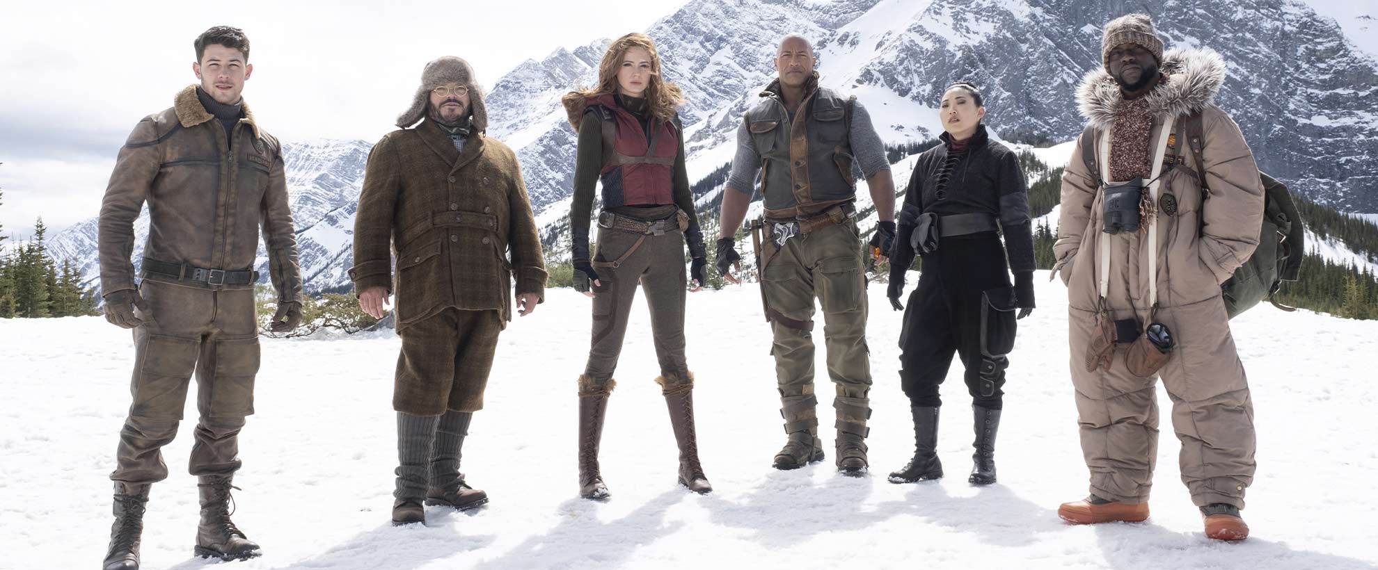 The cast of Jumanji: The Next Level standing on a snowy mountain