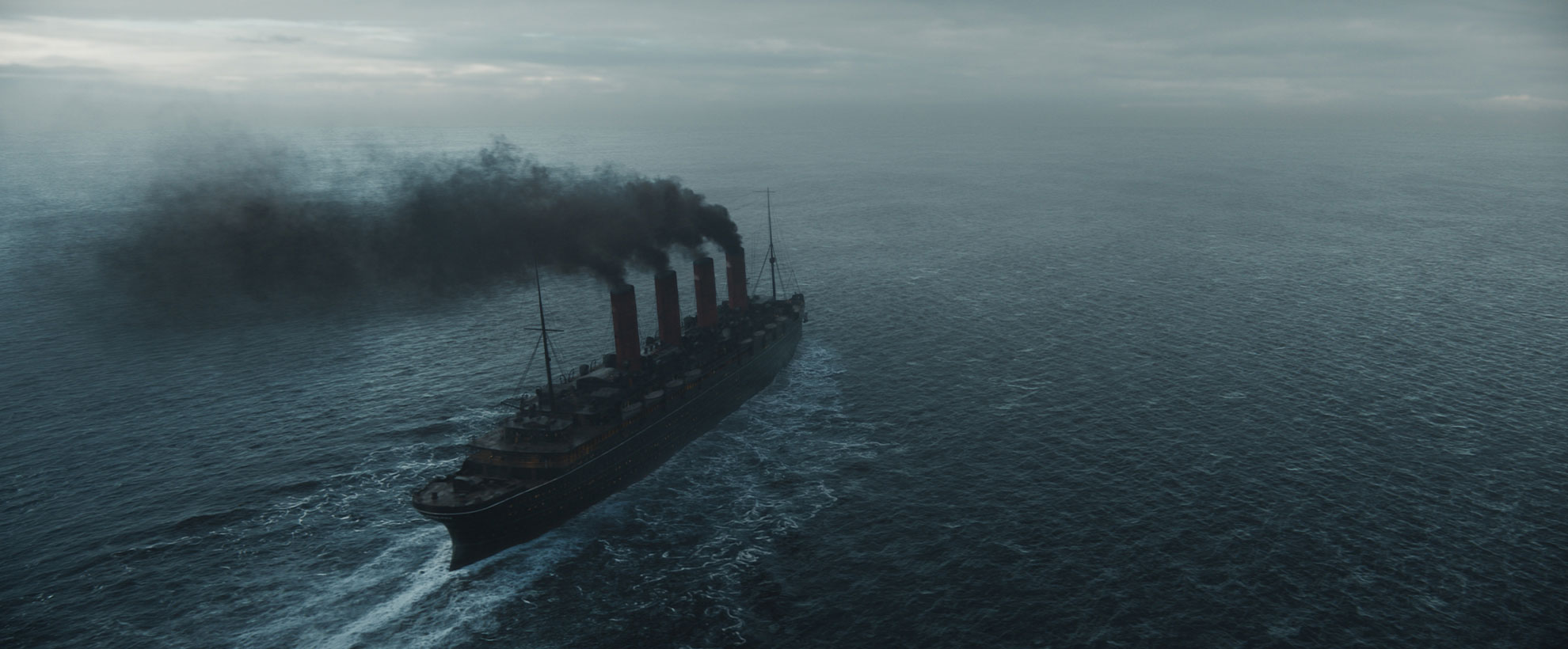 A boat on a wide ocean expanse, with four large smoking chimneys