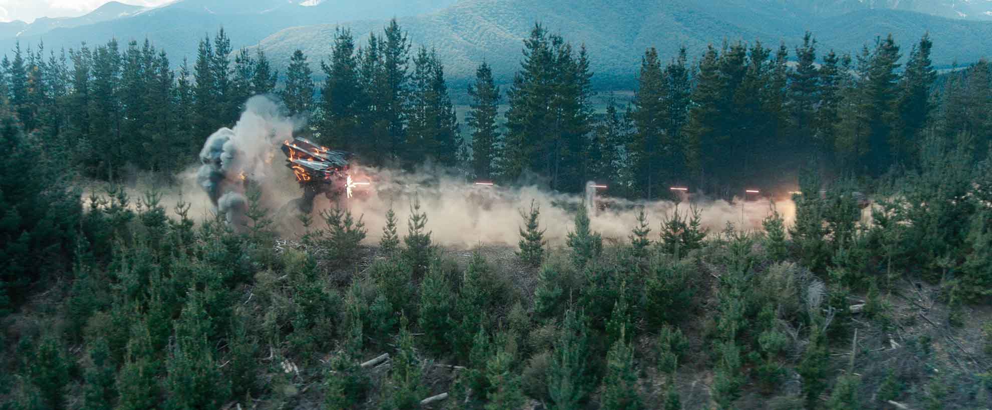 A large CGI robot destroys green woodland