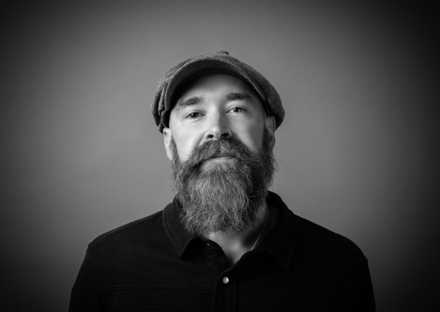 A black and white headshot of Creative Director Sean Cooper.