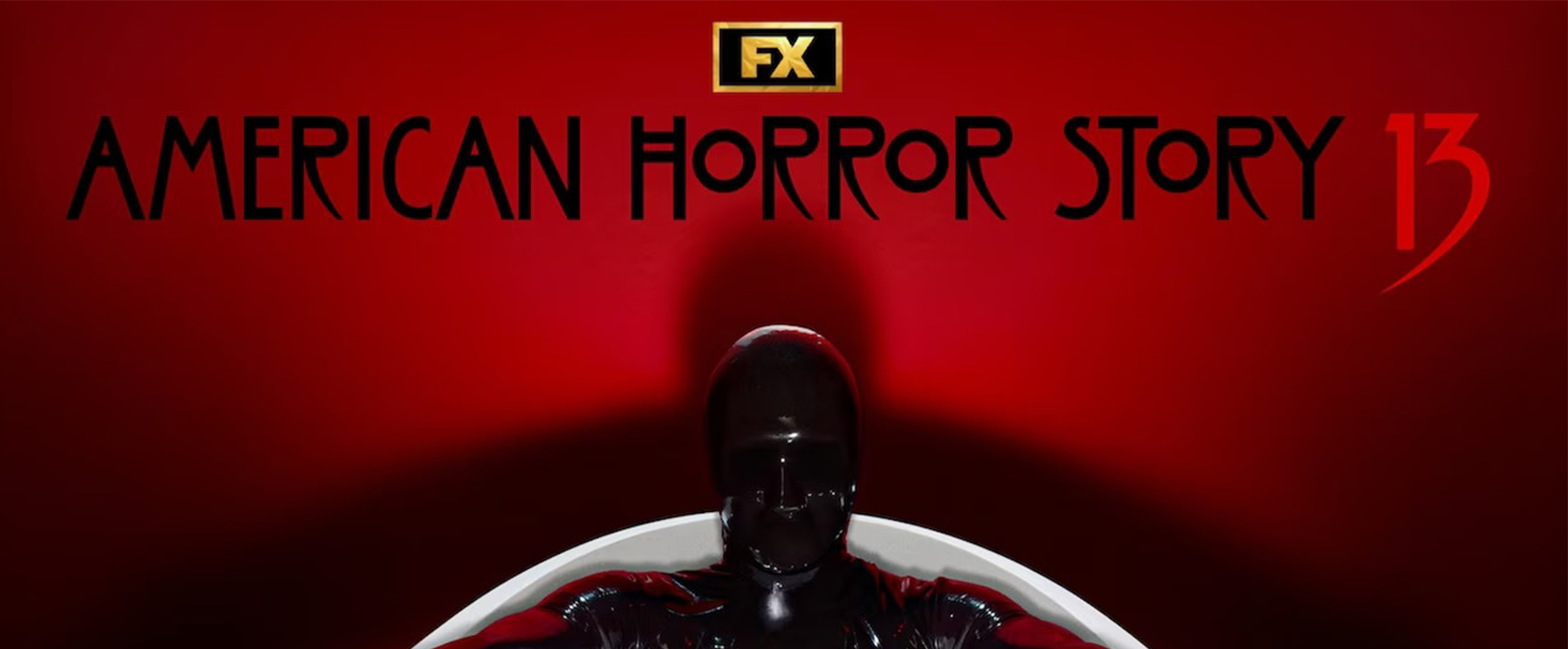 A latex masked black-clad figure sits against a red backdrop beneath the “American Horror Story 13” title.