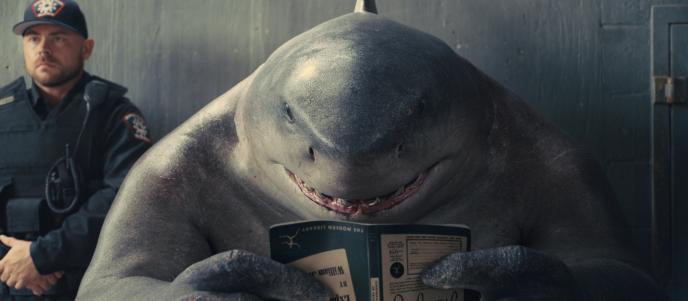 King Shark reading a book upside down