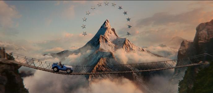 A mountain surrounded by stars, a jeep crosses a bridge in front