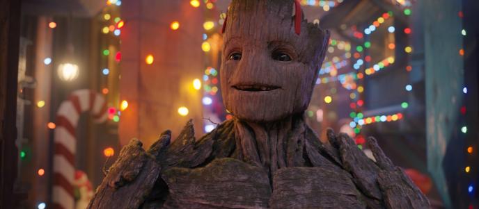 Groot, wearing Christmas antlers and smiling