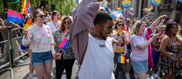 The Framestore team walk in the London Pride march, waving multicoloured Pride flags
