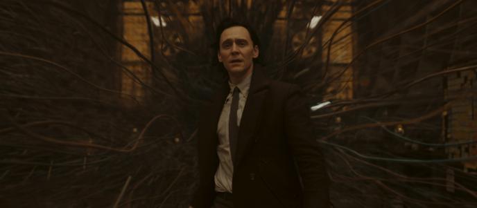 Loki stood in a room as is spaghettifies around him