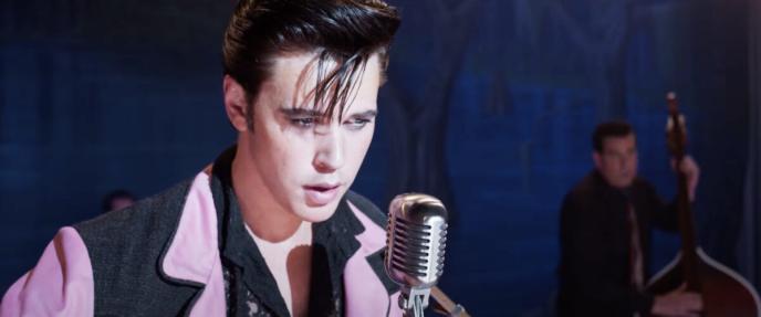 Austin Butler as Elvis, standing in front of a microphone