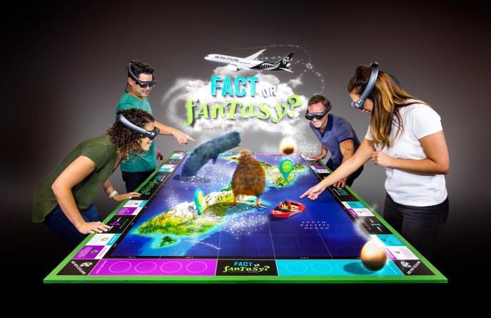 four people wearing VR headsets standing around and pointing at a virtual board game that has the text 'fact or fantasy?' in the centre
