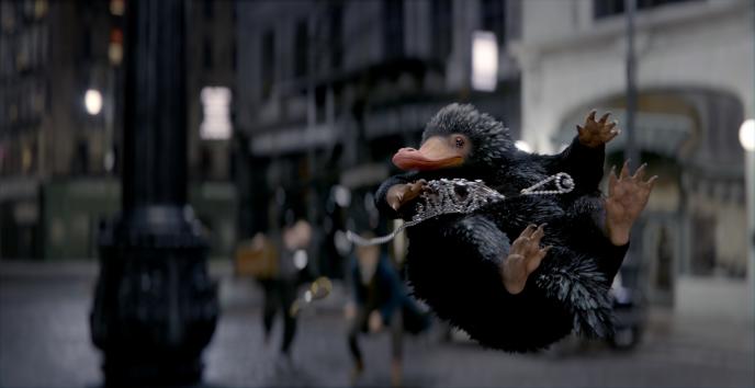 niffler creature from fantastic beasts, mid air, holding a tiara