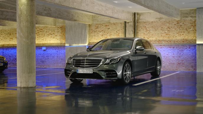front shot of a mercedes benz s class car in a modern car park