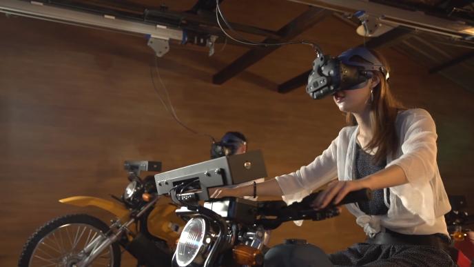 a person wearing a vr headset sitting in a motorcycle-like game device