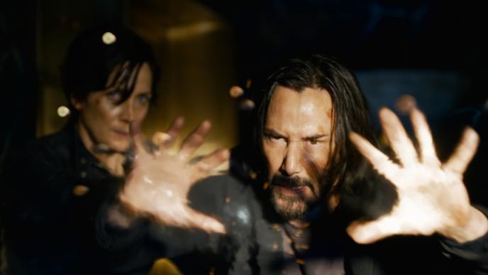 Keanu Reeves as Neo deflects bullets