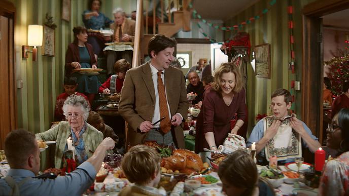 a house full of people eating christmas dinner