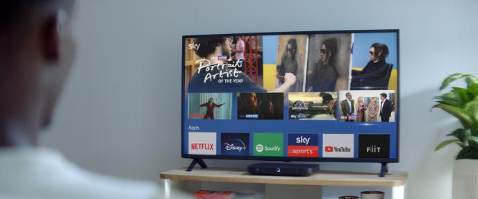 back shot of a person watching television