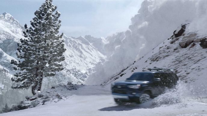 toyota jeep coming out of a snowy mountain