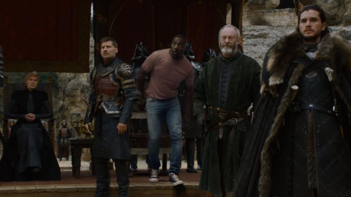 actor idris elba looking intently above surrounded by game of thrones characters