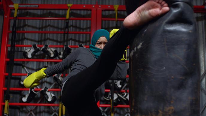 a person in a hijabi training for boxing