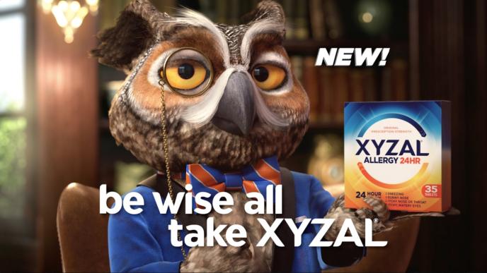 an animated owl wearing a monocle, suit and bow tie. its holding up a box of xyzal allergy tablets. there is text that says 'be wise all, take xyzal' on the bottom centre