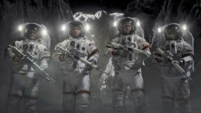 four astronauts standing side by side holding rifle guns