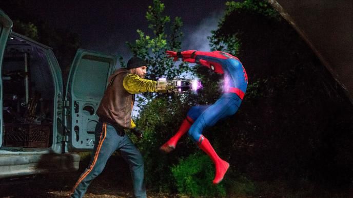spider-man fighting a bad guy