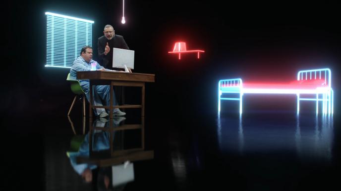 actor jeff goldblum standing next to someone sittting at a desk. there is a holographic bed, shelf and window blinds around the room