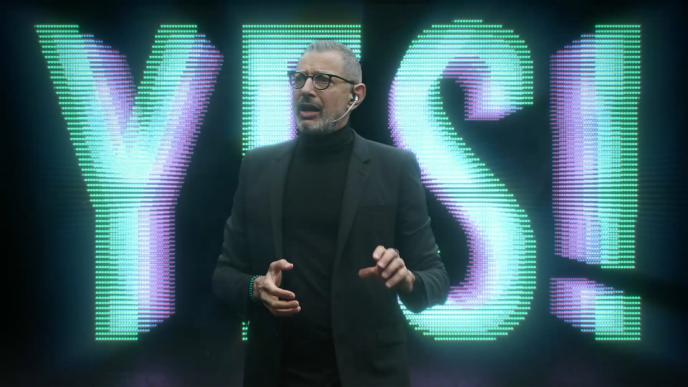 actor jeff goldblum standing in front of text that says 'yes'